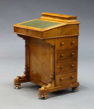 
	
		A Victorian walnut and line inlaid Davenport, the top surmount with compartment for...