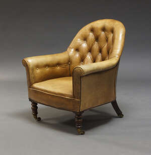 
	
		A Victorian button back armchair,  with close nailed brown leather upholstery, on turned...