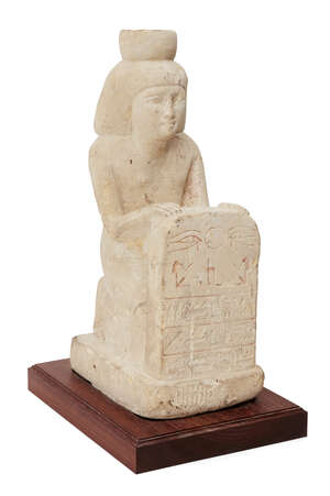 A reproduction limestone Egyptian style stelophorous figure, kneeling and wearing a long kilt, the bag wig surmounted by a hollowed cylindrical crown, the hand