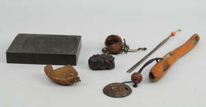 
	
		 
		A Japanese pipecase, late 19th/early 20th century, carved with a seated frog, with a...