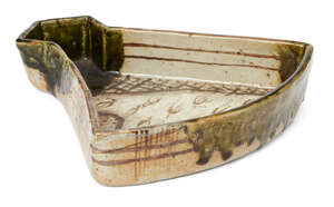 
	
		Kitaoji Rosanjin, Japanese 1883-1959, Oribe-ware fan shaped dish, c.1950s, green glazed...