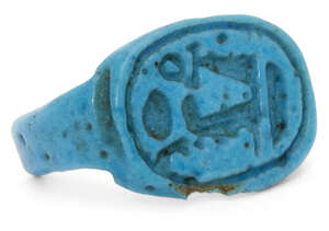 An Egyptian bright blue glazed faience ring inscribed with the throne name of Pharaoh Amenhotep III Nebmaatre, a.1390-1352 BC., ring band broken and minor dama