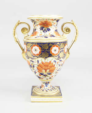 
	
		A Derby porcelain twin handled urn, 19th century, decorated in the Imari palate, on a...