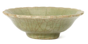 A Chinese Longquan celadon bowl, Ming dynasty, with shaped rim and impressed floral motif to central reserve, unglazed foot rim, 13cm diameter 
		 