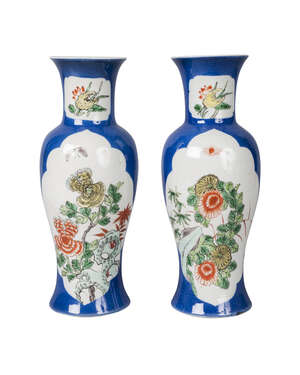 A pair of Chinese porcelain baluster vases, 19th century, painted with panels in famille verte enamels with blossoming chrysanthemum and peony on a powder blue