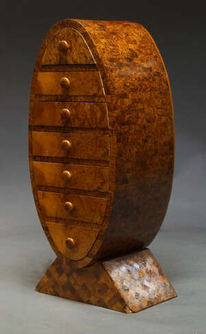 
	
		An Art Deco style burr yew chest of drawers, recent manufacture, of oval form, with seven...
