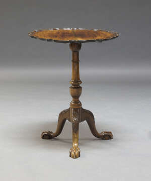 
	
		A George III and later mahogany tilt top occasional table, the pie crust top, raised on...
