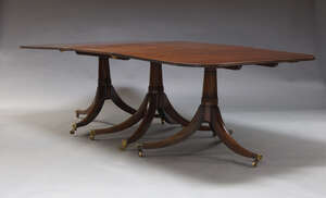 
	
		A George III style triple pedestal mahogany dining table, mid 20th Century, the rounded...