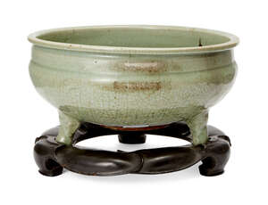 
	
		A large Chinese grey stoneware Longquan celadon tripod censer, Ming dynasty, carved to...