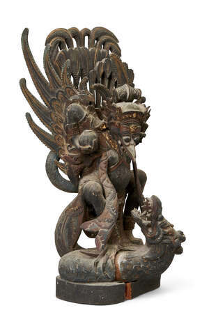 
	
		A Balinese wood carving, early 20th century, carved as a wing deity attacking a dragon,...