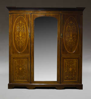 
	
		An Edwardian mahogany and inlaid triple wardrobe by Maple  & Co, the moulded cornice...