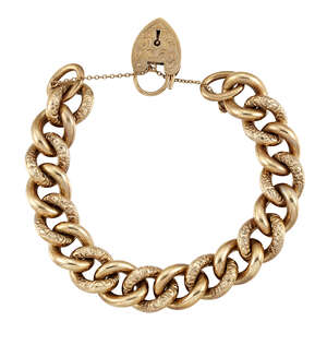 A 9ct gold bracelet, of curb link design, alternate links with scroll decoration to a padlock clasp, bracelet with Birmingham hallmarks, 1979, padlock with Lon