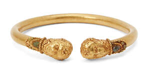 A reproduction Greek-style gold bracelet with applied terminals in the form of a female wearing a looped beaded necklace inlaid with green stones, 8cm diam. 48