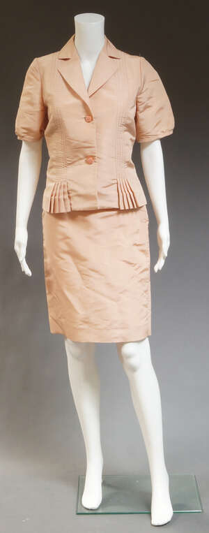 
	
		John Galliano, a dusky pink silk short sleeve jacket and skirt, the jacket with pleated...