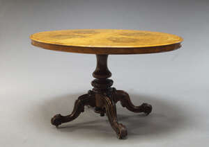 
	
		A Victorian burr walnut loo table, the oval quarter veneered top above central turned and...