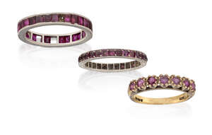 
	
		Two ruby eternity rings and a ruby half-hoop ring, one eternity ring composed of a line...