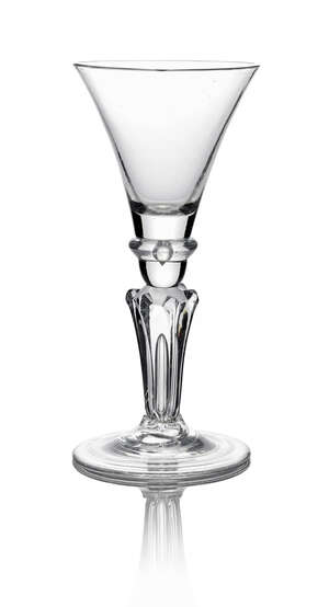 A George II wine goblet, c. 1730, the trumpet bowl with tooled angular knop above a six pointed stared pedestal stem, on conical folded foot, 19.3cm high 
		