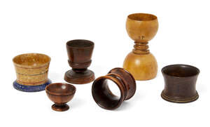 
	
		A group of treen items, 19th century, comprising: a lignum vitae dice shaker, a salt in...