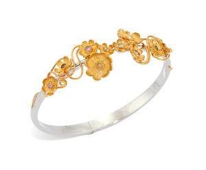 A diamond and coloured diamond torque bangle, the upper half decorated with floral clusters set...
