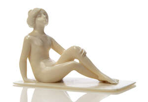
	
		A Carved ivory figure 
		c.1920, unsigned 
		Carved as a naked woman sitting on the...