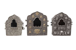 
	
		Three Tibetan silver and copper backed gaus, 19th century, two repousse decorated with...