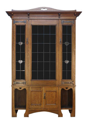 
	
		An Art Nouveau oak bookcase, 
		c.1905,
		The moulded cornice surmounted by arched...