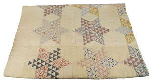 
	
		An American cotton patchwork quilted coverlet, 1930s, worked in multiple patterned...