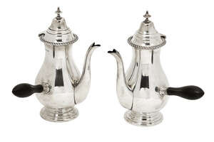 
	
		A pair of silver café-au-lait pots, Birmingham, c.1919, S Blanckensee & Son Ltd, both of...