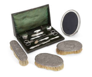 
	
		An Edwardian silver mounted manicure set in fitted case, Birmingham, c.1906, Levi &...