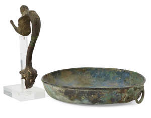 A Roman bronze dish with lion mask handle, 21.3cm maximum diam., and Roman bronze handle, a siren where the handle joins the vessel rim, her arms outstretched,