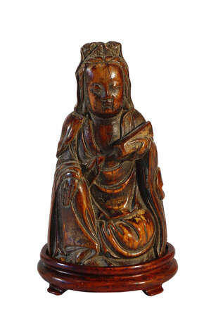 
	
		A Chinese ivory carving of Guanyin, Ming dynasty, carved seated holding a scroll box in...