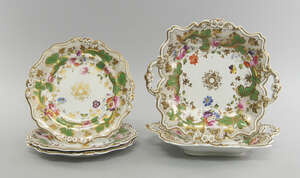 A pair of English porcelain square form plates, mid 19th century, with twin handles, decorated with sprays of flowers and gilt and green foliate, 28cm wide fro