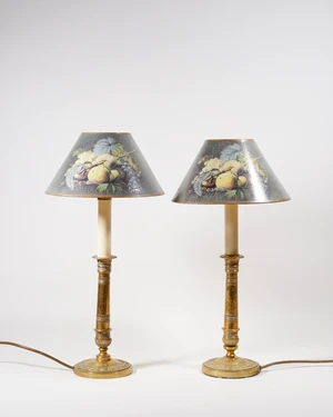 A pair of French Charles X style brass candlestick lamp bases, 20th century, with painted green...