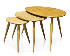 
	
		Ercol, a nest of three light elm  and beech 'Pebble' tables 
		c.1980, with applied...