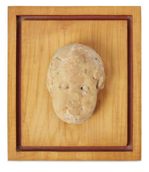 A Roman marble head of a young boy, possibly Eros, 9cm high  
		Provenance: Property of a Belgian estate 
		 