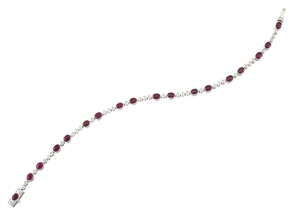 
	
		A ruby and diamond line bracelet, composed of a series of oval ruby collets with...