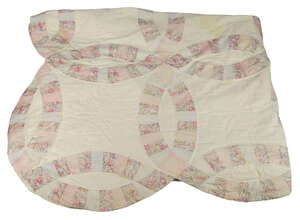 
	
		An American Double Wedding Ring patchwork quilt, circa 1900, pieced from floral printed...