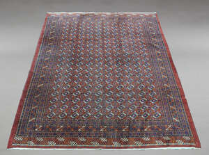 
	
		A Bokhara carpet, mid-20th century, the central rectangular reserve set with ten rows of...