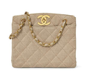 
	
		Chanel: a quilted buff coloured fabric bag, with two internal zippered wall pockets, ...