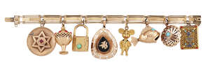 A charm bracelet, of rectangular link design suspending various charms, including: a fish with turquoise cabochon eyes; an incense burner with coral, corallium