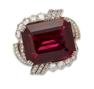 
	
		A rubellite and diamond brooch,  centring on a cut-cornered rectangular rubellite...