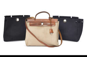 
	
		Hermes: an Hermes tan leather and fabric Her bag,  together with two outer covers, one...