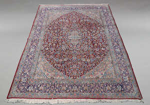 
	
		A large Kirman woolen carpet, mid-20th Century, with central pole medallion, decorated...