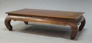 
	
		A Chinese stained hardwood low table, 20th Century, the rectangular top on curved legs,...