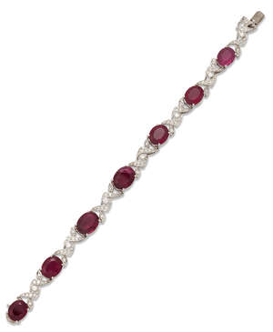 
	
		A rubellite and diamond bracelet, 1950s,  designed as a graduated line of oval mixed-cut...