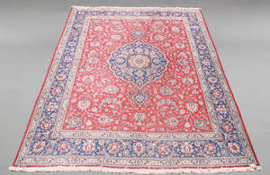 
	
		A large woolen Tabriz carpet, the central reserve with pole medallion surrounded by...