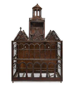 
	
		A large wirework bird cage, of architectural form, late 19th/20th century, with an...