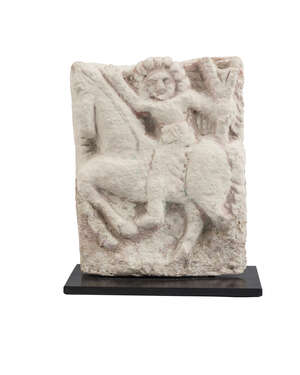 A limestone plaque depicting a man on horse, Byzantine, circa 4th-6th century AD, mounted on a rectangular base, 10 x 7.5cm. 
		 
		Provenance: Collection o