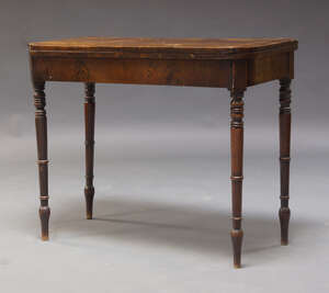 
	
		A George IV mahogany card table, the fold over top enclosing green baize lined playing...