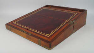 
	
		A mahogany and brass bound writing slope, mid 19th century, the interior inset with a red...